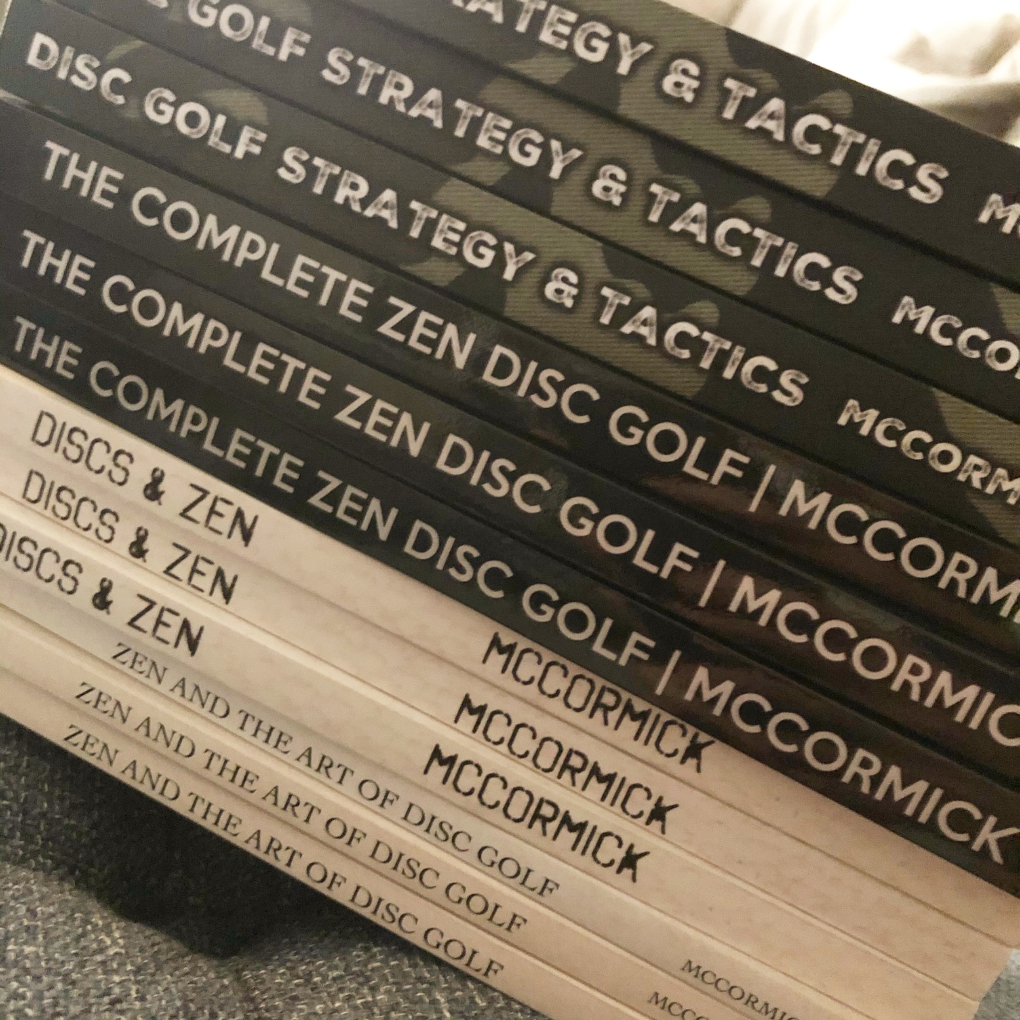 Stacks of printed Zen Disc Golf books