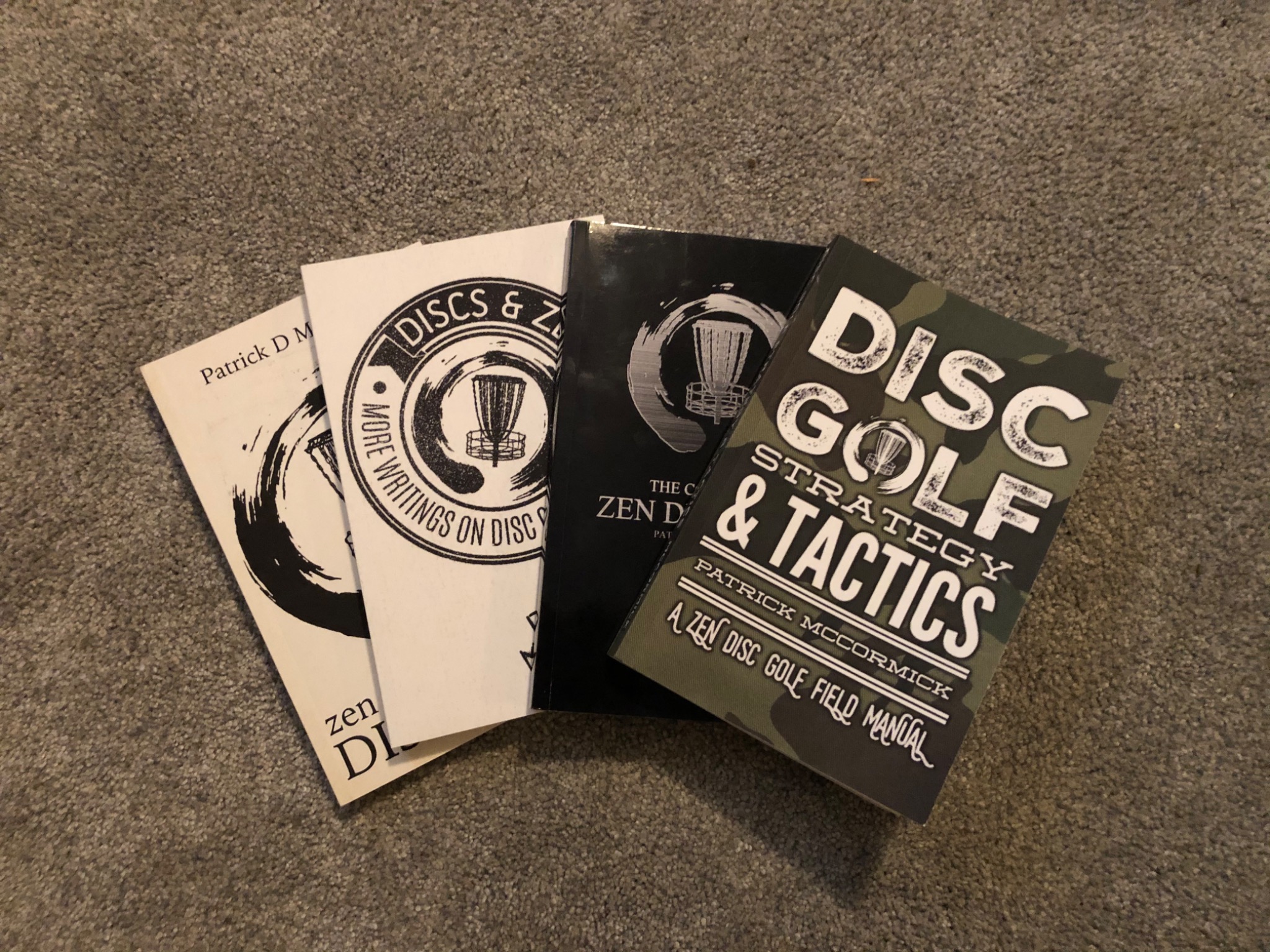 The Zen Disc Golf books laid out together
